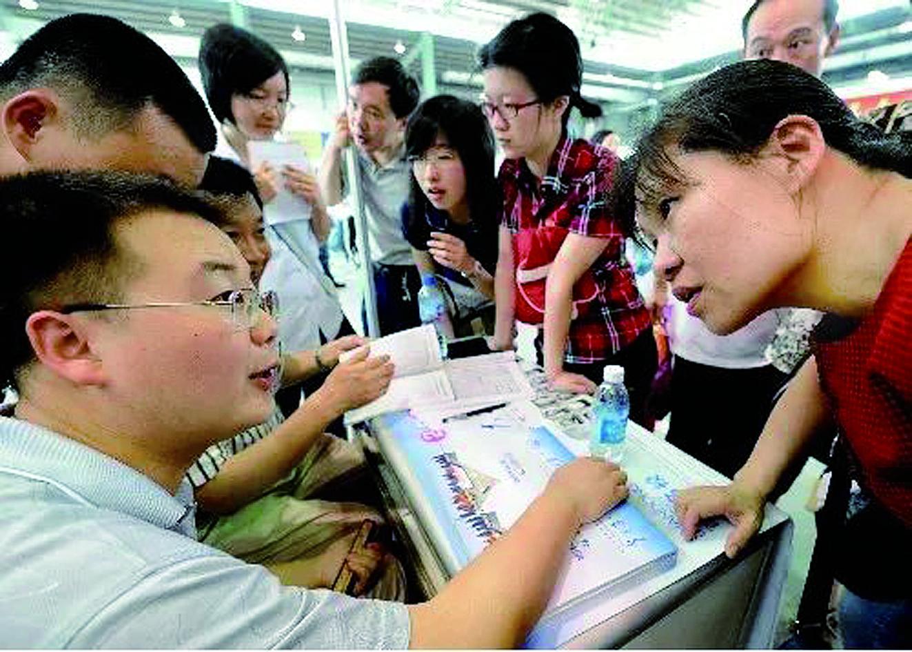 一位考生家长(右一)在高招填报志愿咨询会上咨询